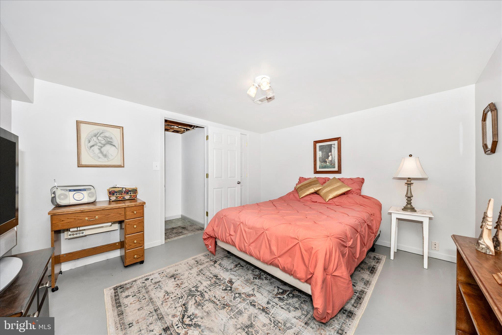 4432 Valley View Road Middletown, MD 21769 - Photo 32 of 54 a bedroom with a bed dresser and a lamp on table