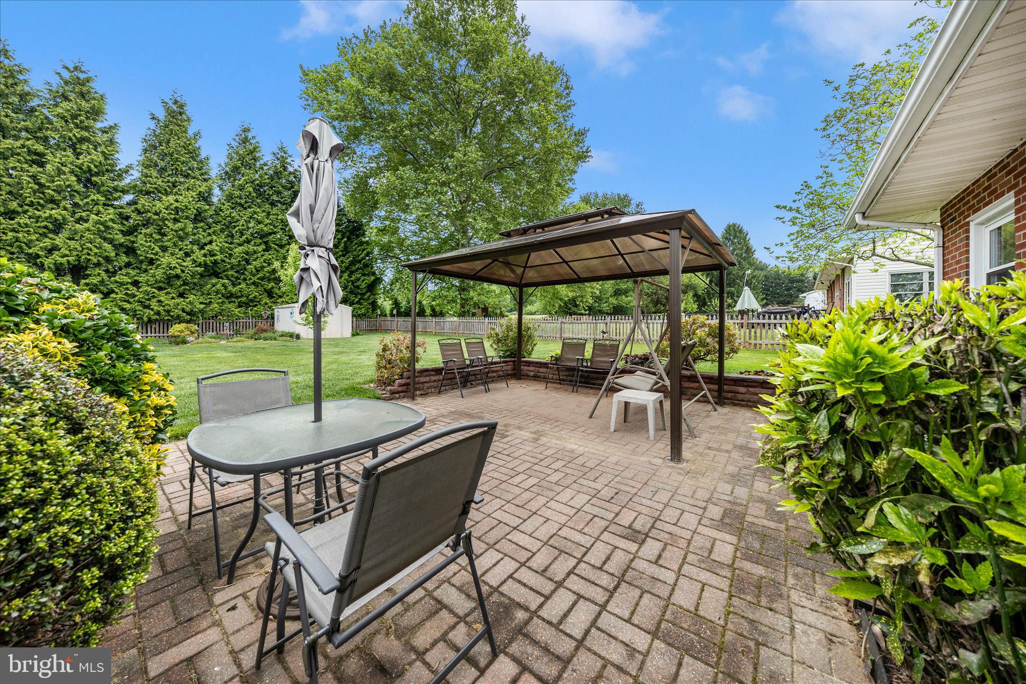 4432 Valley View Road Middletown, MD 21769 - Photo 51 of 54 a view of a patio with a table and chairs under an umbrella