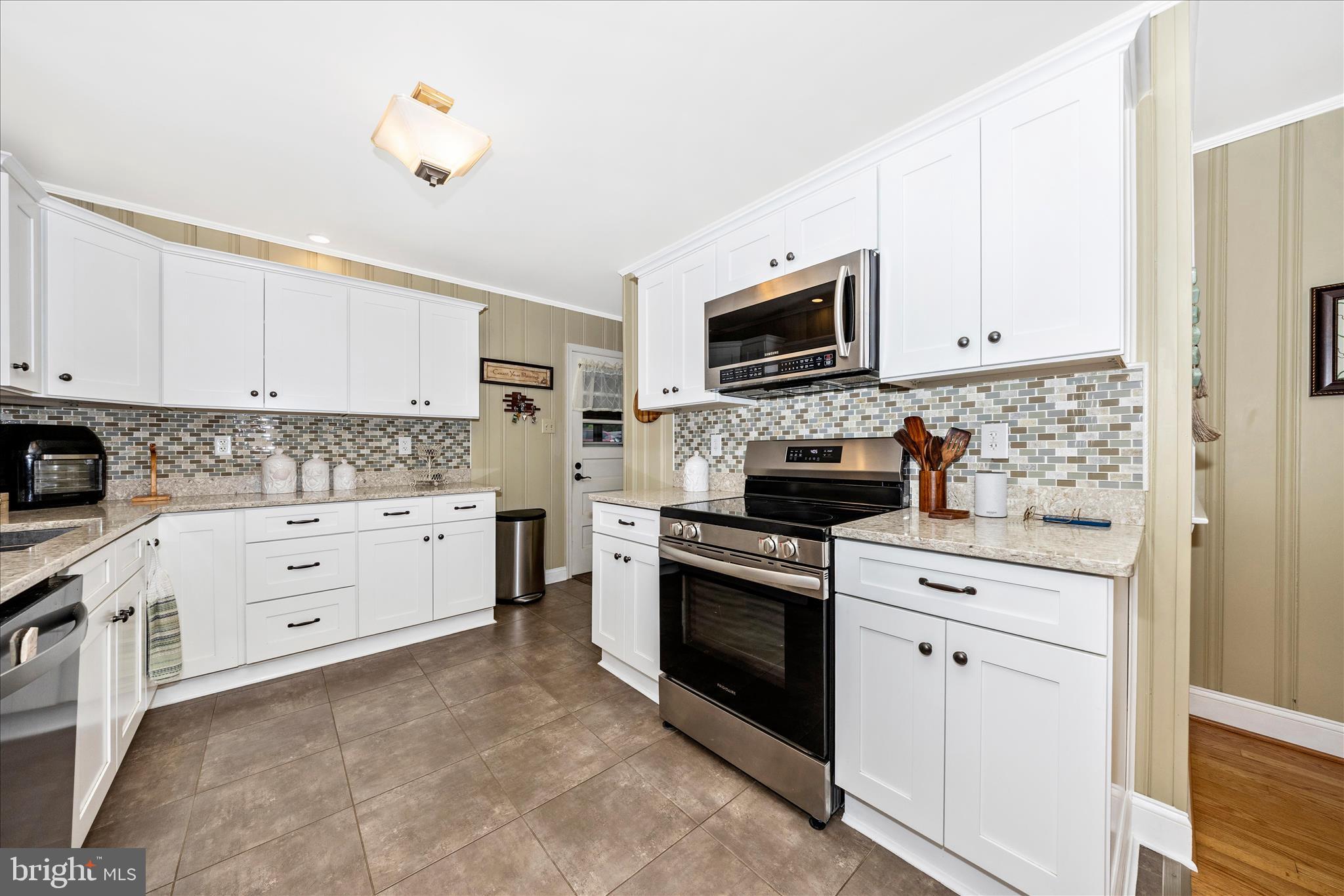 4432 Valley View Road Middletown, MD 21769 - Photo 10 of 54 a kitchen with white cabinets and stainless steel appliances