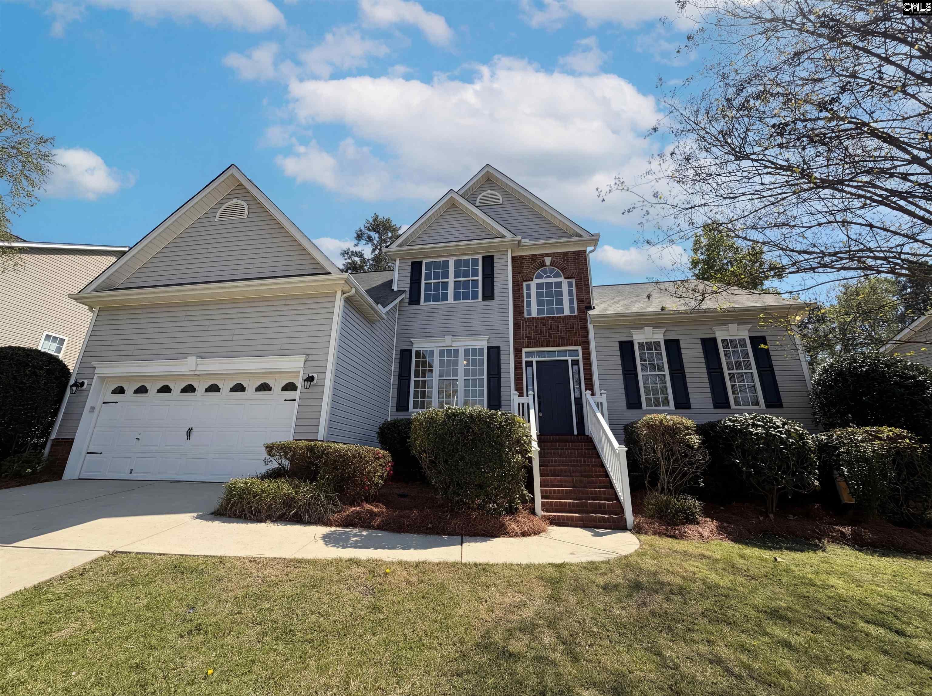 112 Coopers Hawk Circle Irmo, SC 29063 - Photo 8 of 26 a front view of a house with a yard and garage