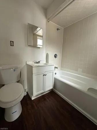 a bathroom with a toilet a sink and bathtub