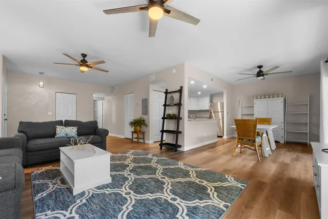 a living room with furniture and kitchen view