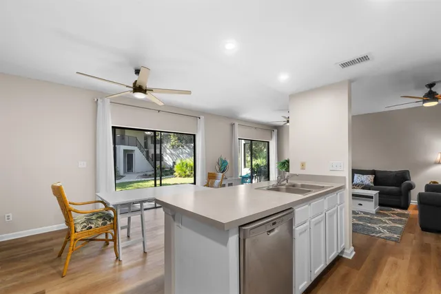 a kitchen with stainless steel appliances a sink a stove a microwave a sink and cabinets