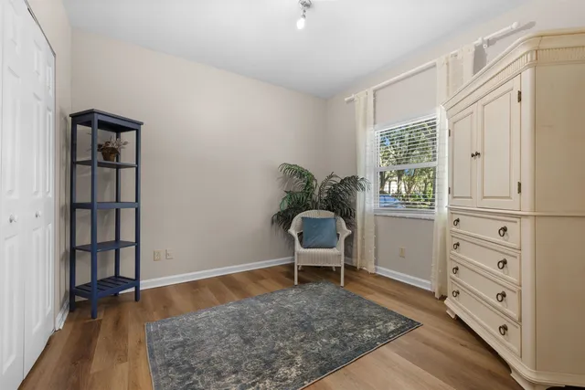 a view of empty room with wooden floor and cabinet