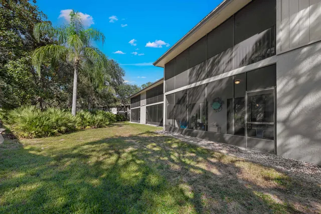 an aerial view of a house with garden space ocean and mountain view in back