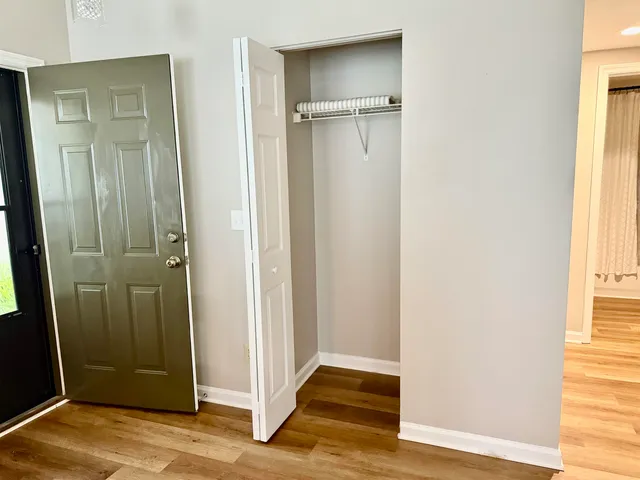 a living room with furniture and potted plants