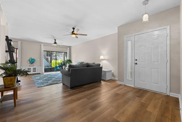 a living room with furniture and a floor to ceiling window