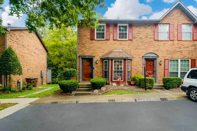 a front view of a house with a yard and a garage