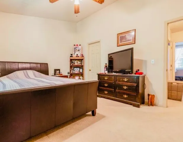 a bedroom with a bed and flat screen tv