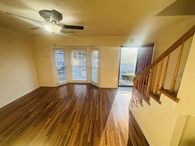 a view of a room with wooden floor and staircase
