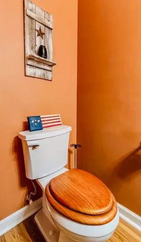 a bathroom with a toilet and a mirror