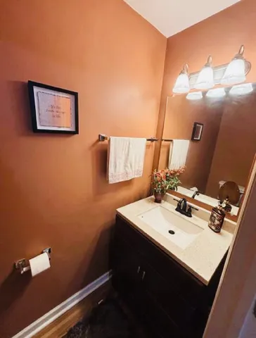 a bathroom with a sink mirror and vanity