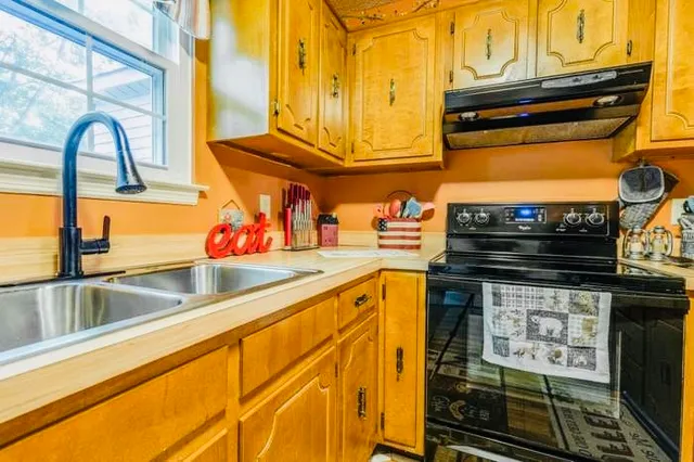 a kitchen with stainless steel appliances granite countertop a stove and a microwave