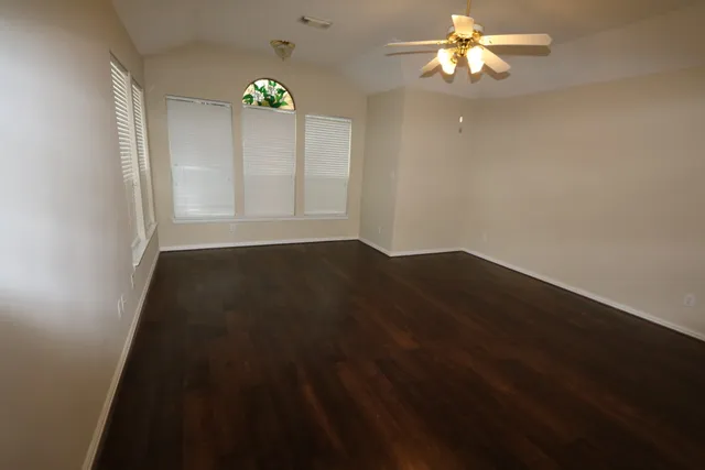 wooden floor in an empty room with a window