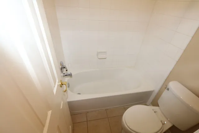 an empty room with closet and windows