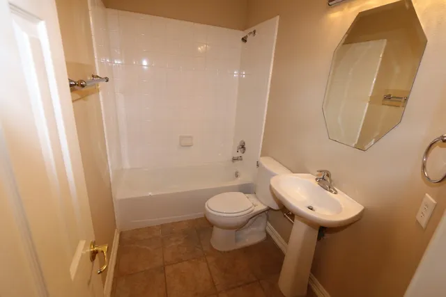 en empty room with windows and chandelier fan