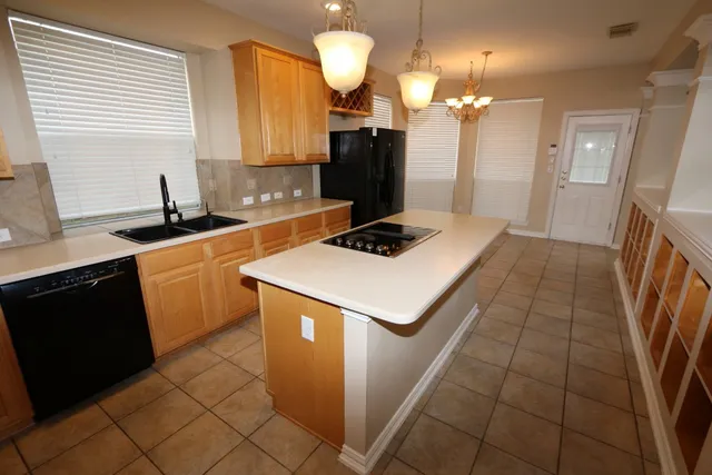 a kitchen with a sink appliances and cabinets