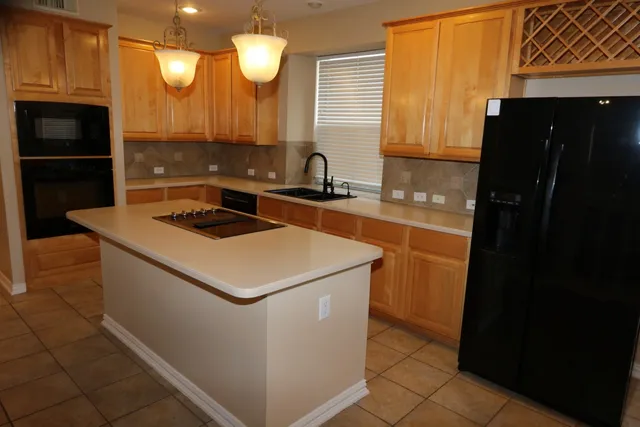 a kitchen with a sink and a refrigerator
