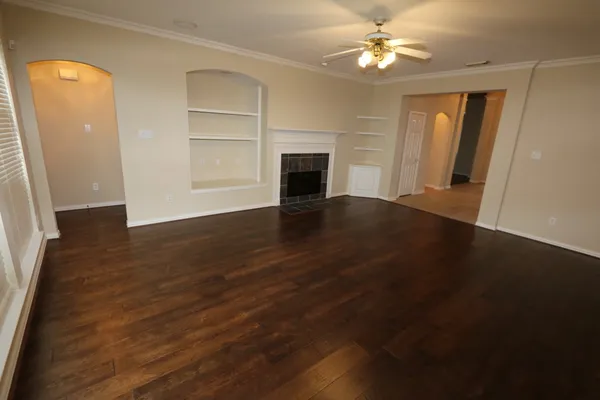 wooden floor in an empty room with a fireplace