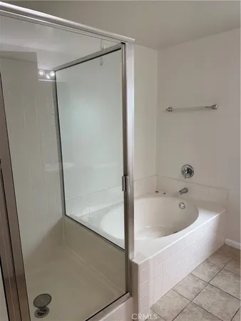 a bathroom with double vanity and a mirror