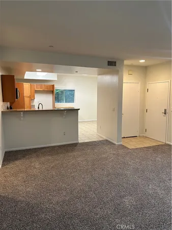 a view of a kitchen with a sink and cabinet area