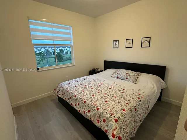 a bed sitting in a bedroom next to a window