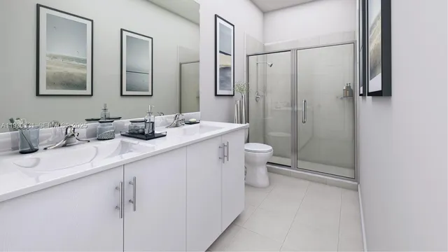 a bathroom with a double vanity sink toilet mirror and shower