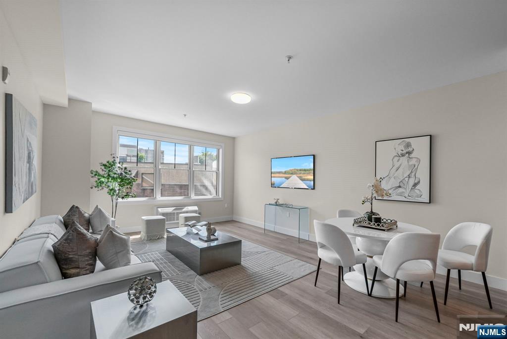 2021 Jones Road, Unit 102 Fort Lee, NJ 07024 - Photo 1 of 11 a living room with furniture and a large window