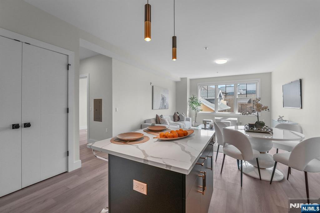 2021 Jones Road, Unit 102 Fort Lee, NJ 07024 - Photo 6 of 11 a view of a dining room with furniture window and wooden floor