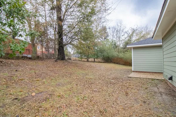 a view of a house with a yard and garage