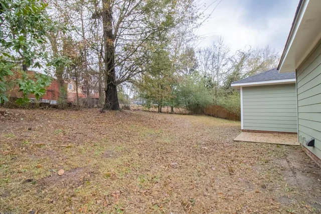 a view of a house with a yard and garage