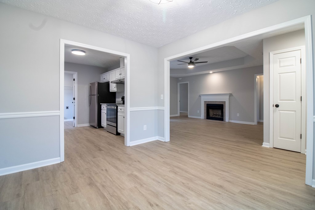7001 Hunter Hill Court Columbus, GA 31907 - Photo 3 of 19 an empty room with wooden floor and a kitchen