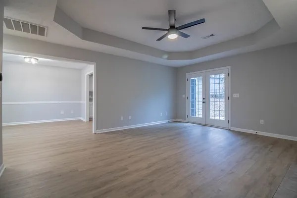 wooden floor in an empty room with a window