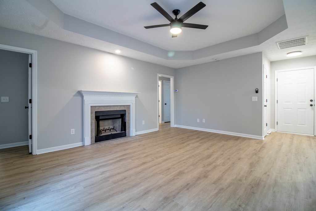 7001 Hunter Hill Court Columbus, GA 31907 - Photo 10 of 19 a view of an empty room with wooden floor fireplace and a window