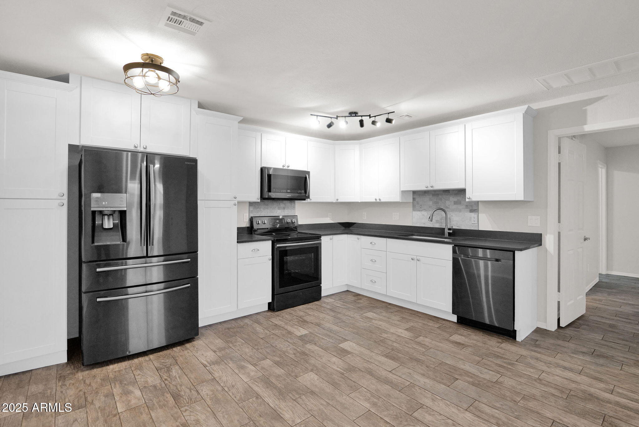 1440 North Idaho Road, Unit 1021 Apache Junction, AZ 85119 - Photo 1 of 26 a kitchen with granite countertop a refrigerator stove and microwave