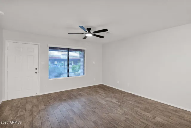 a view of room with a ceiling fan and window
