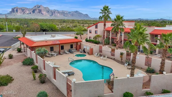 an aerial view of a house with a swimming pool outdoor seating and yard