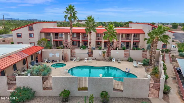an aerial view of a house with swimming pool and furniture