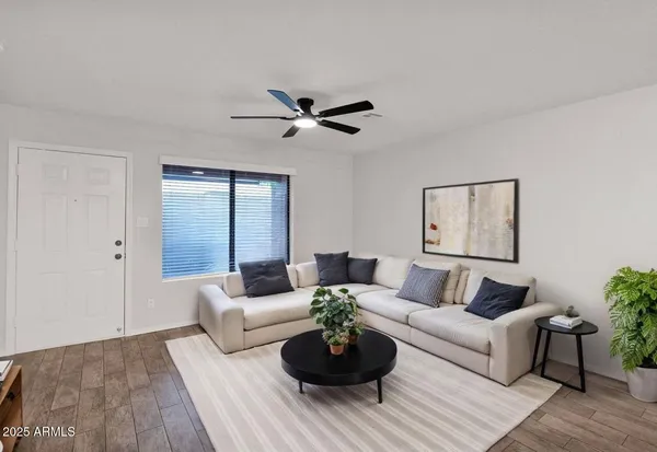 a living room with furniture potted plant and window