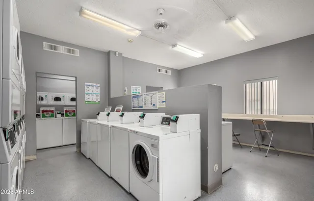 a utility room with closet dryer and washer