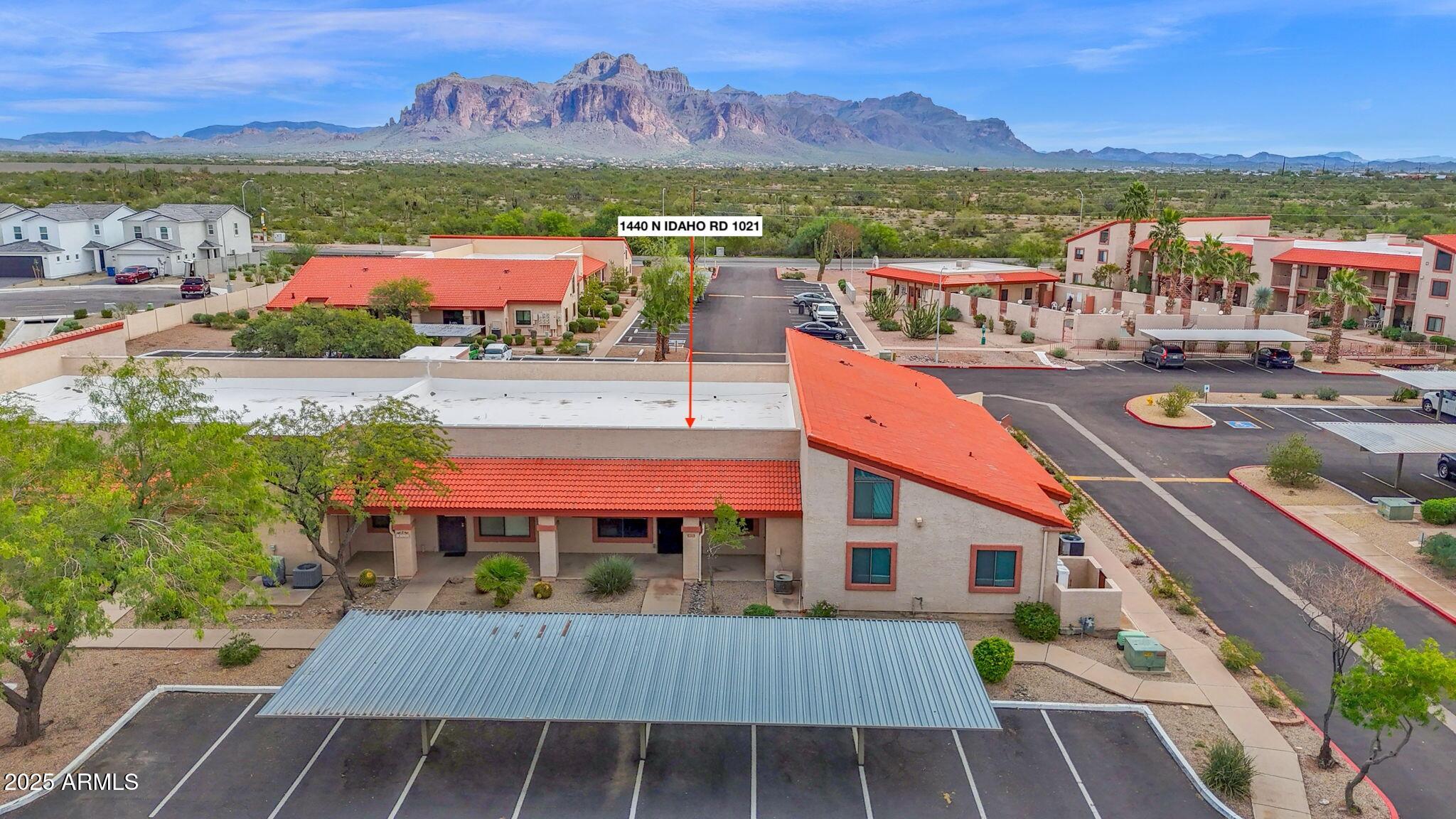 1440 North Idaho Road, Unit 1021 Apache Junction, AZ 85119 - Photo 22 of 24 an aerial view of residential houses with outdoor space and swimming pool