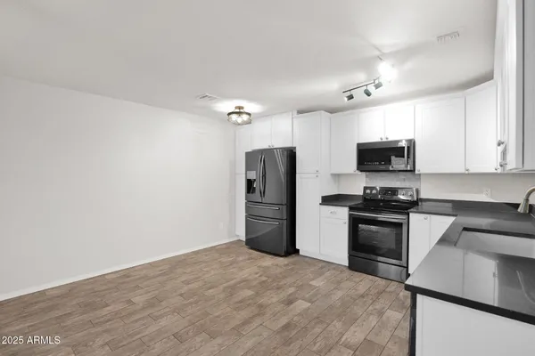 a kitchen with a refrigerator stove and microwave