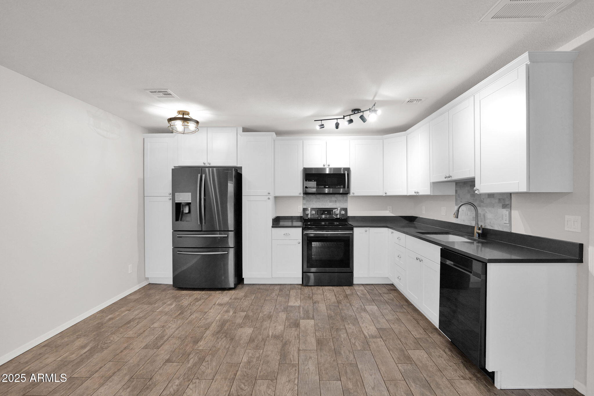 1440 North Idaho Road, Unit 1021 Apache Junction, AZ 85119 - Photo 5 of 24 a kitchen with a refrigerator cabinets and wooden floor