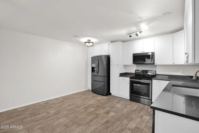 a kitchen with a refrigerator stove and microwave