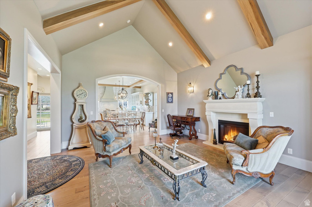 930 Price Farm Court Midway, UT 84049 - Photo 2 of 42 Living area featuring quarter sawn white oak flooring, vaulted ceiling, and fireplace