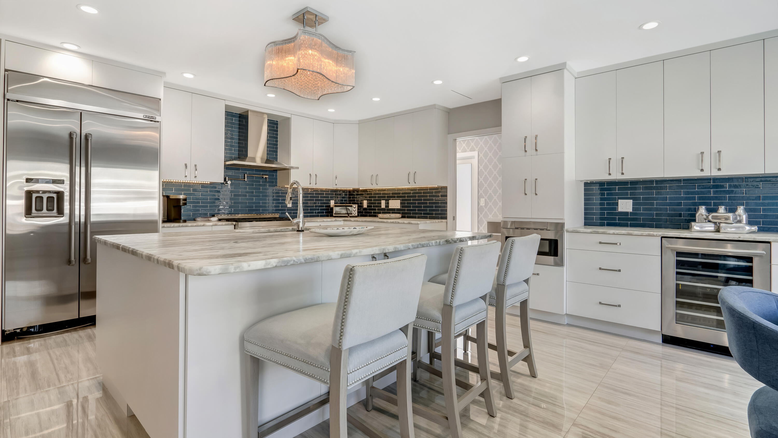 831 Dover Street Boca Raton, FL 33487 - Photo 14 of 54 a kitchen with stainless steel appliances kitchen island granite countertop a kitchen island and chairs in it