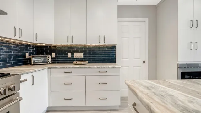 a kitchen with stainless steel appliances granite countertop a stove and a refrigerator