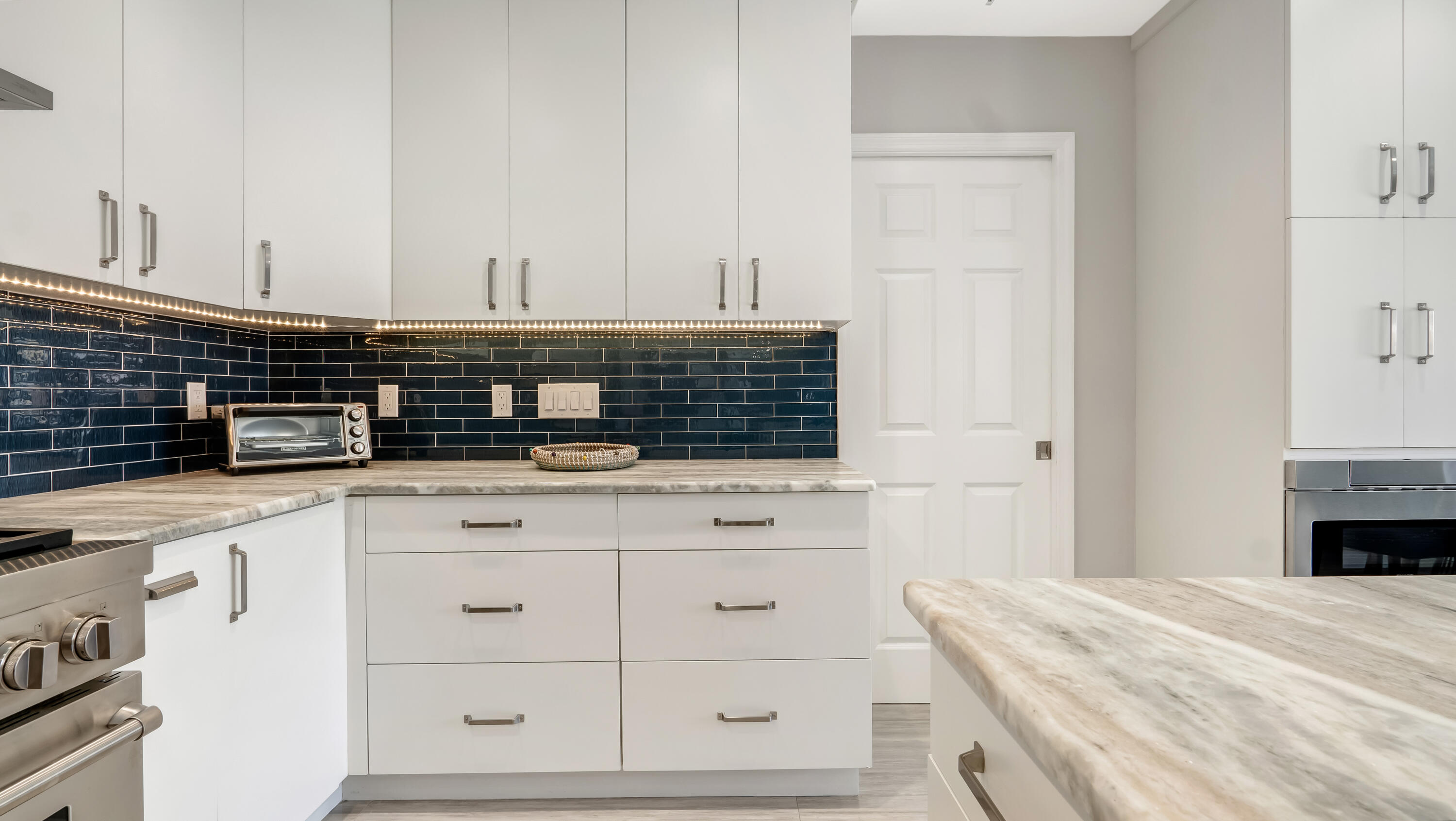 831 Dover Street Boca Raton, FL 33487 - Photo 16 of 54 a kitchen with white cabinets and sink