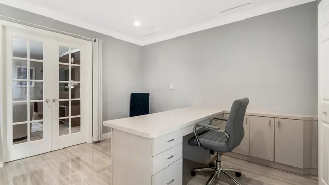 a bathroom with a granite countertop sink a toilet and a large mirror