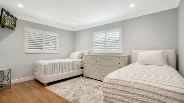 a bedroom with a bed and a painting on the wall